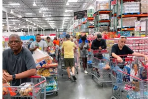 Shoppers wait in a check-out line at a Costco wholesale store in Orlando