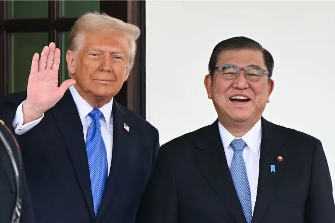 President Donald Trump waves as he greets Japanese Prime Minister Shigeru Ishiba upon arrival outside the West Wing of the White House in Washington